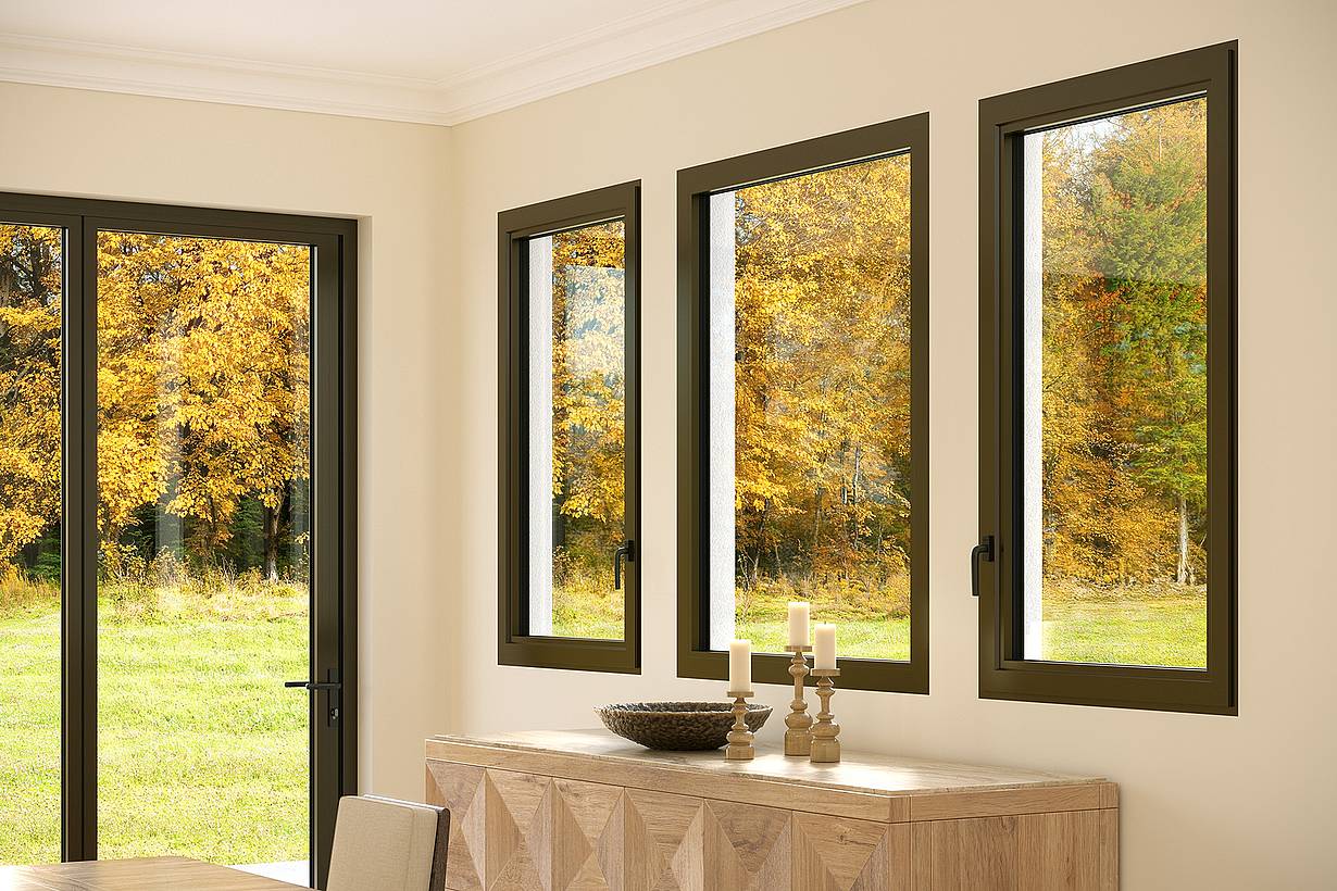 Three fixed windows in a beige dining room reveal an autumn landscape with trees and grass. 