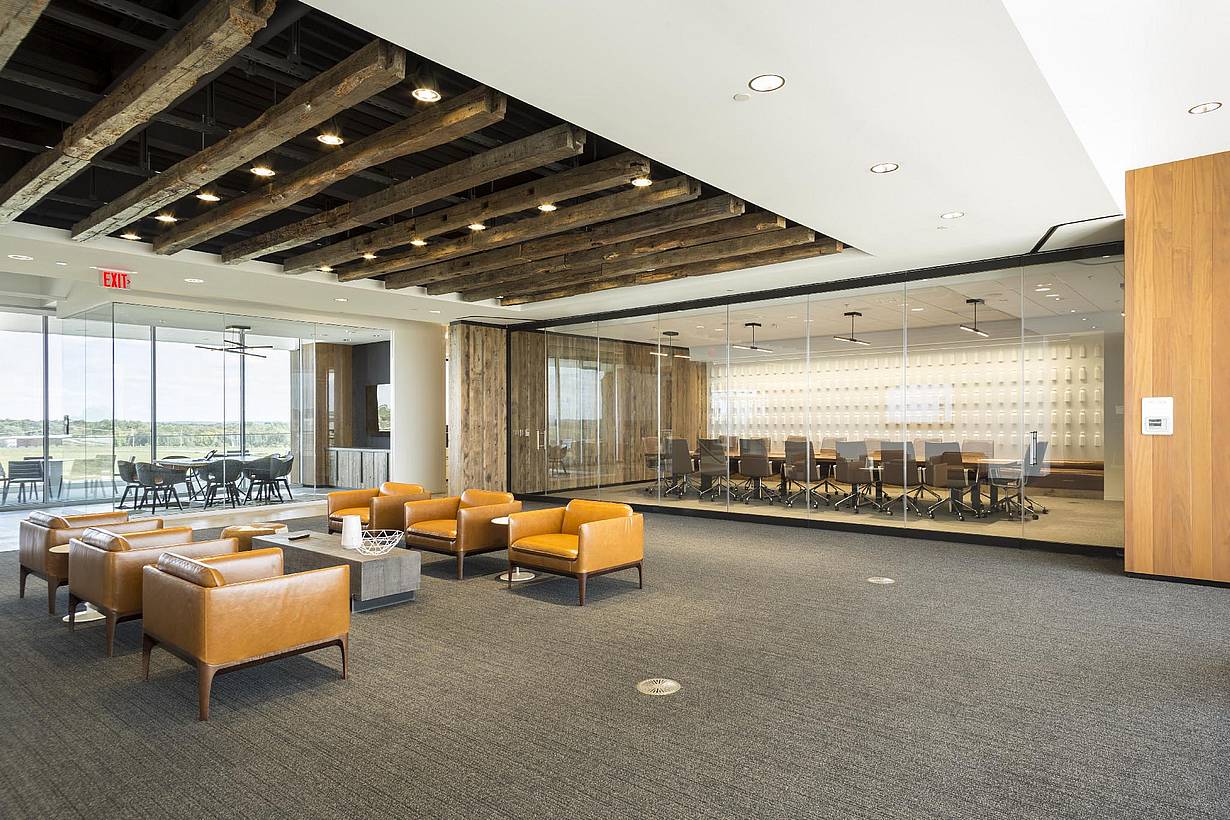 Office space with NanaWall PrivaSEE sliding partitions creating a meeting room within an open plan