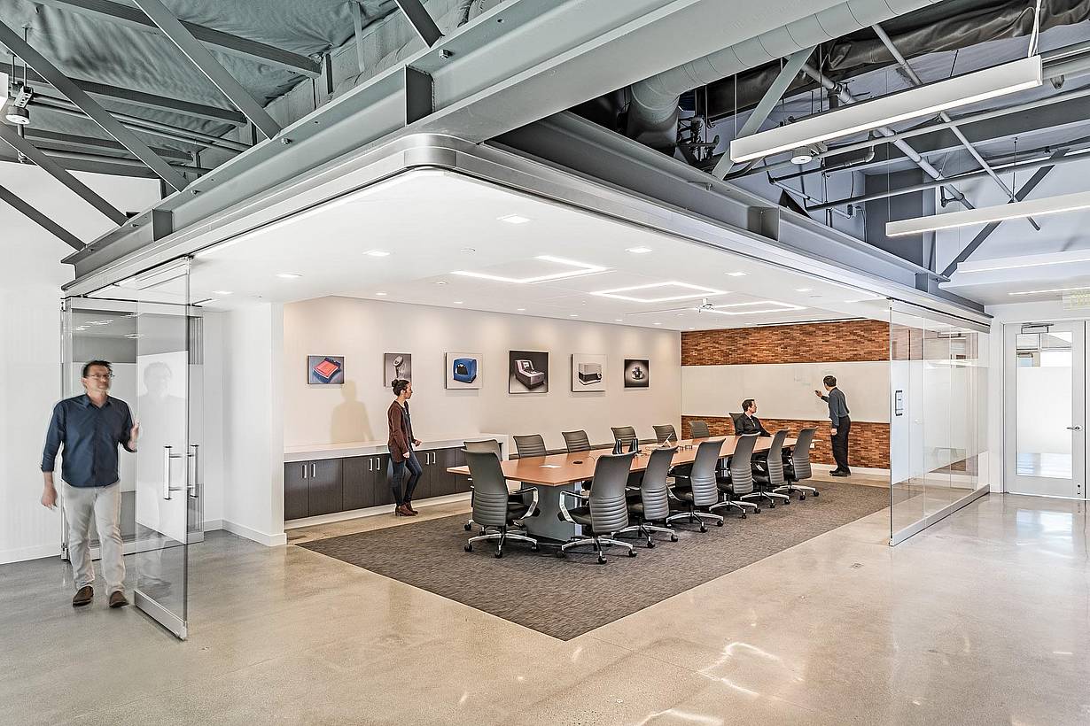 Office collaboration space with NanaWall HSW75 operable glass walls creating a flexible meeting space