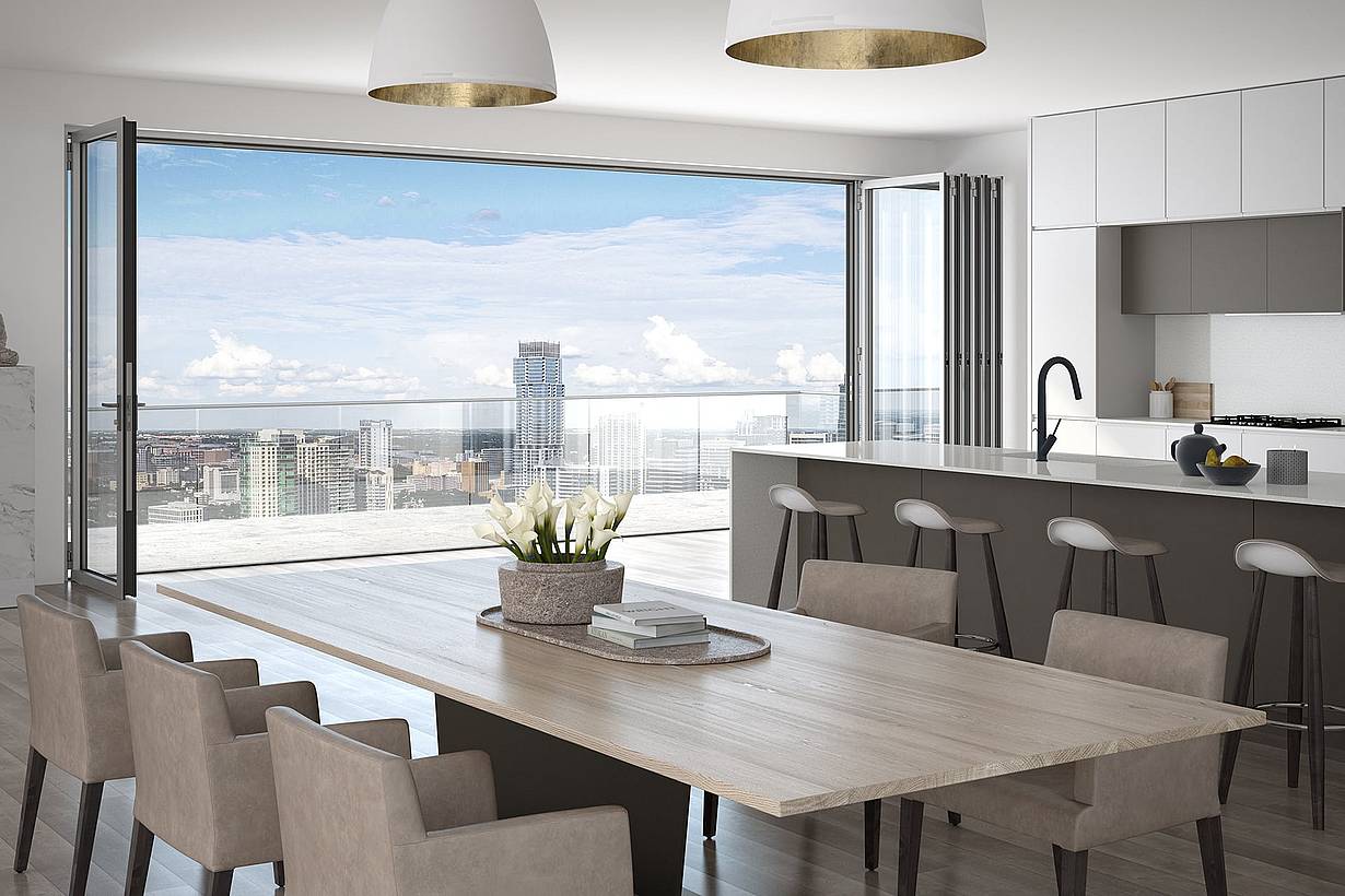 A kitchen with a table and chairs and a view of the city