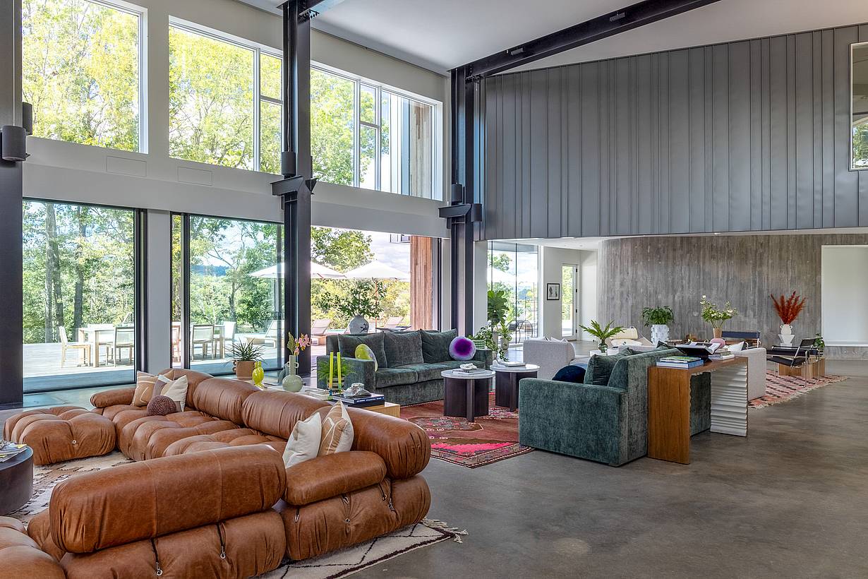 Modern living room with transom windows, opening glass doors, and direct access to the patio.