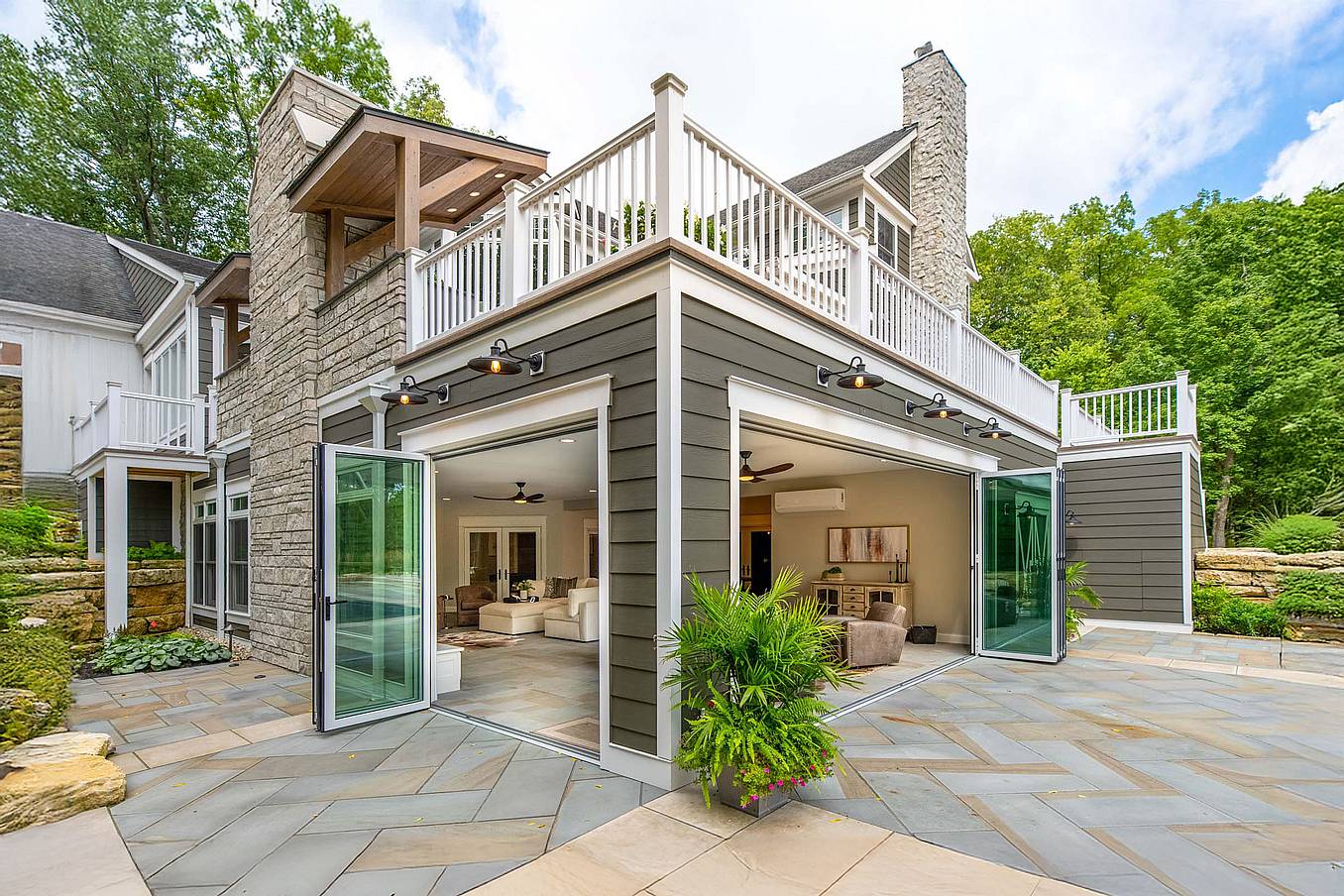 Accordion glass doors at Columbus, OH River House, creating a seamless four-season sunroom with modern indoor-outdoor flow