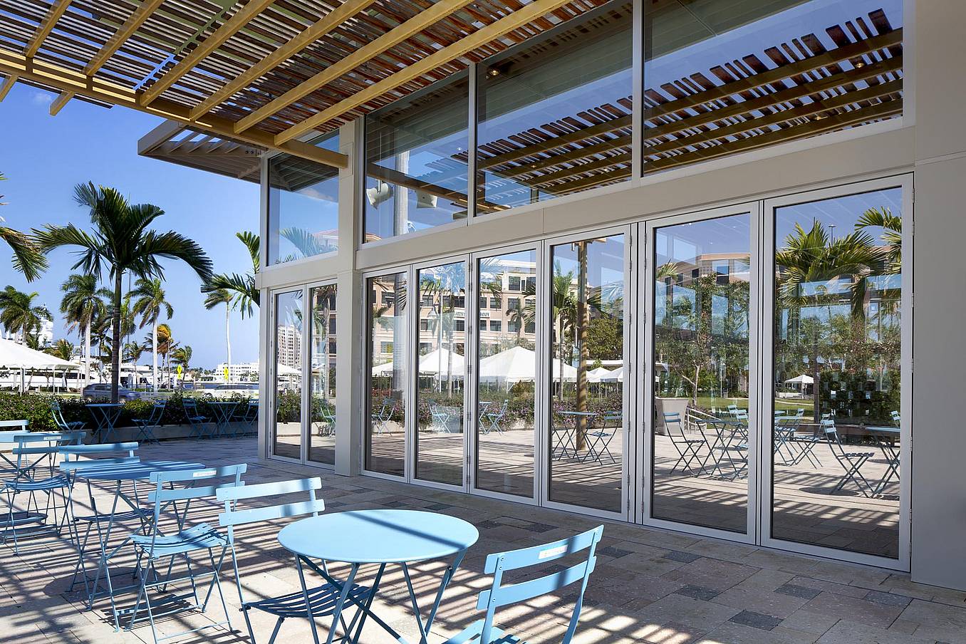 Weather resistant folding glass walls 