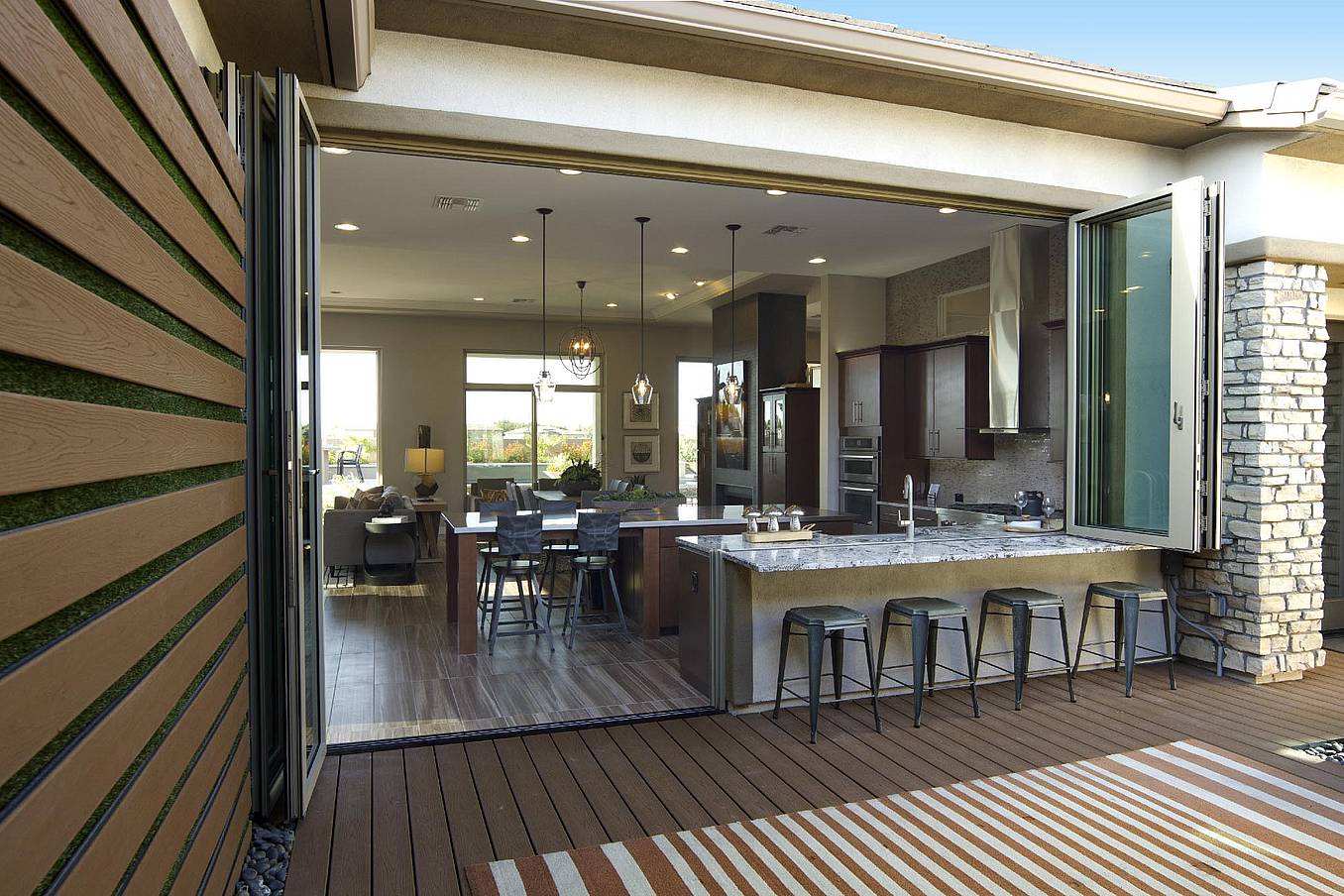 NanaWall SL70 folding glass wall system at an Ashton Woods residence in Arizona, opening a living area to an outdoor patio