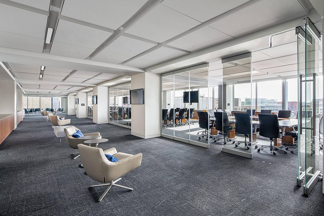 Management consulting firm office with NanaWall PrivaSEE sliding glass partitions creating private meeting rooms