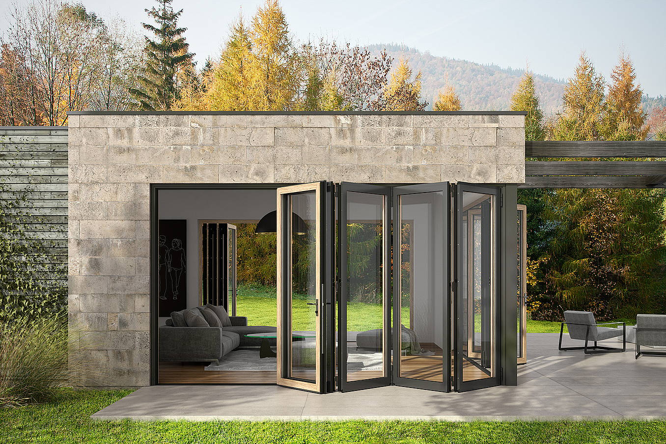 A modern ADU with open aluminum clad bifold glass doors leading from a living room to a patio, surrounded by trees and outdoor seating.