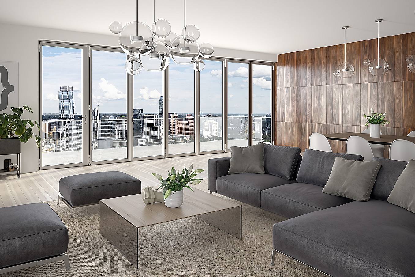 A high rise living room with folding glass walls providing a panoramic view of the city
