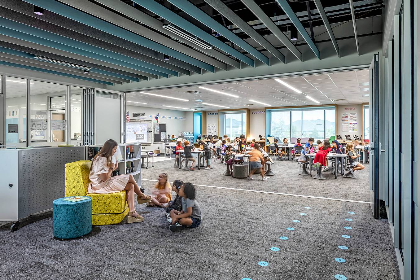 Modern classroom with acoustical commercial folding glass doors and bright lighting, creating an ideal education environment.