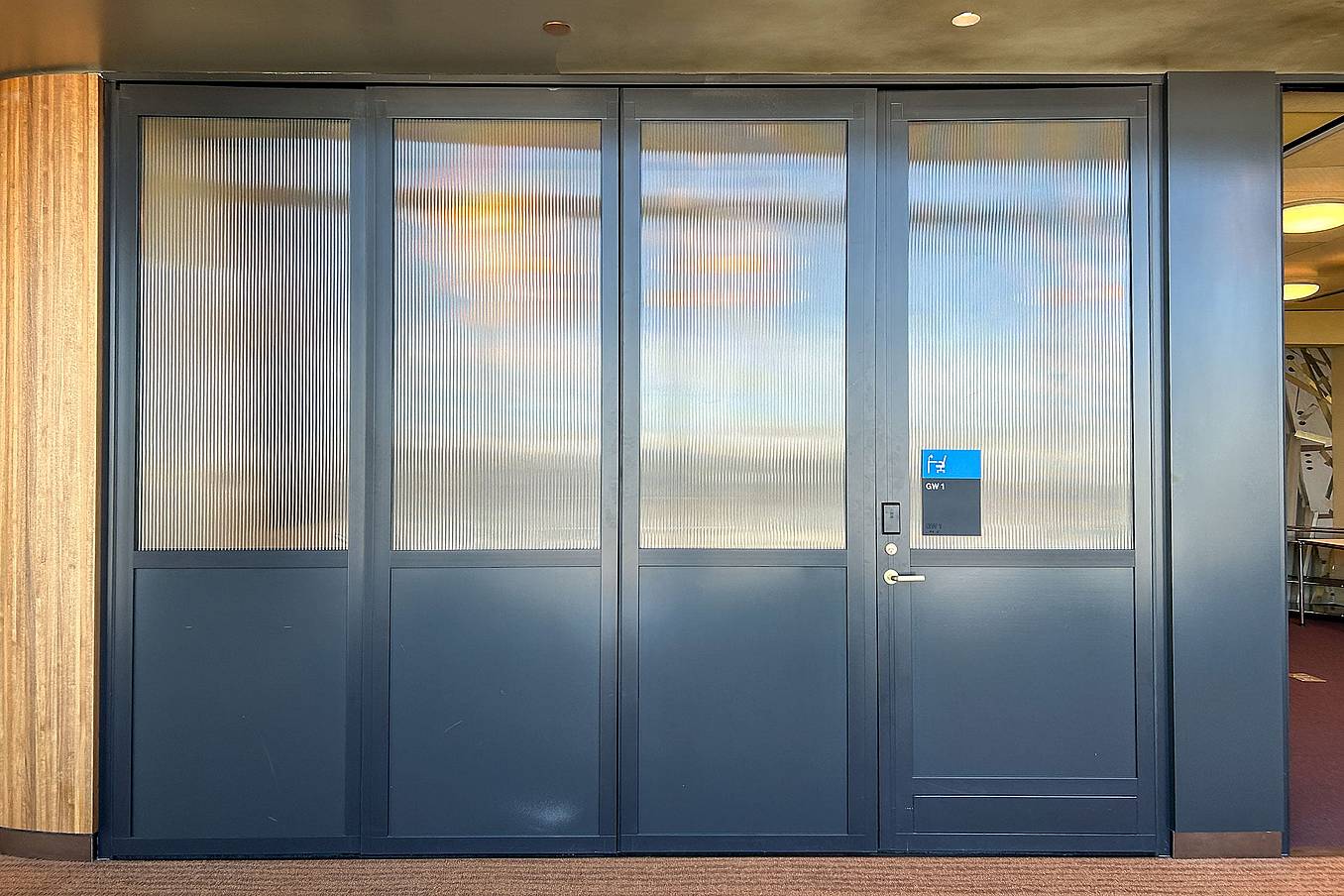 Closed NanaWall stacking glass doors with translucent panels providing privacy in a conference room setting
