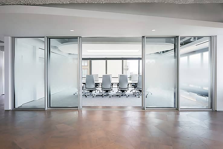 cero floor-to-ceiling sliding glass walls enclosing a conference room at Visa One Market