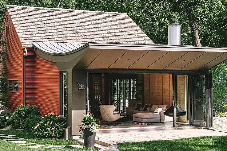 Red barn-style home with large NanaWall SL60 folding glass doors open to patio