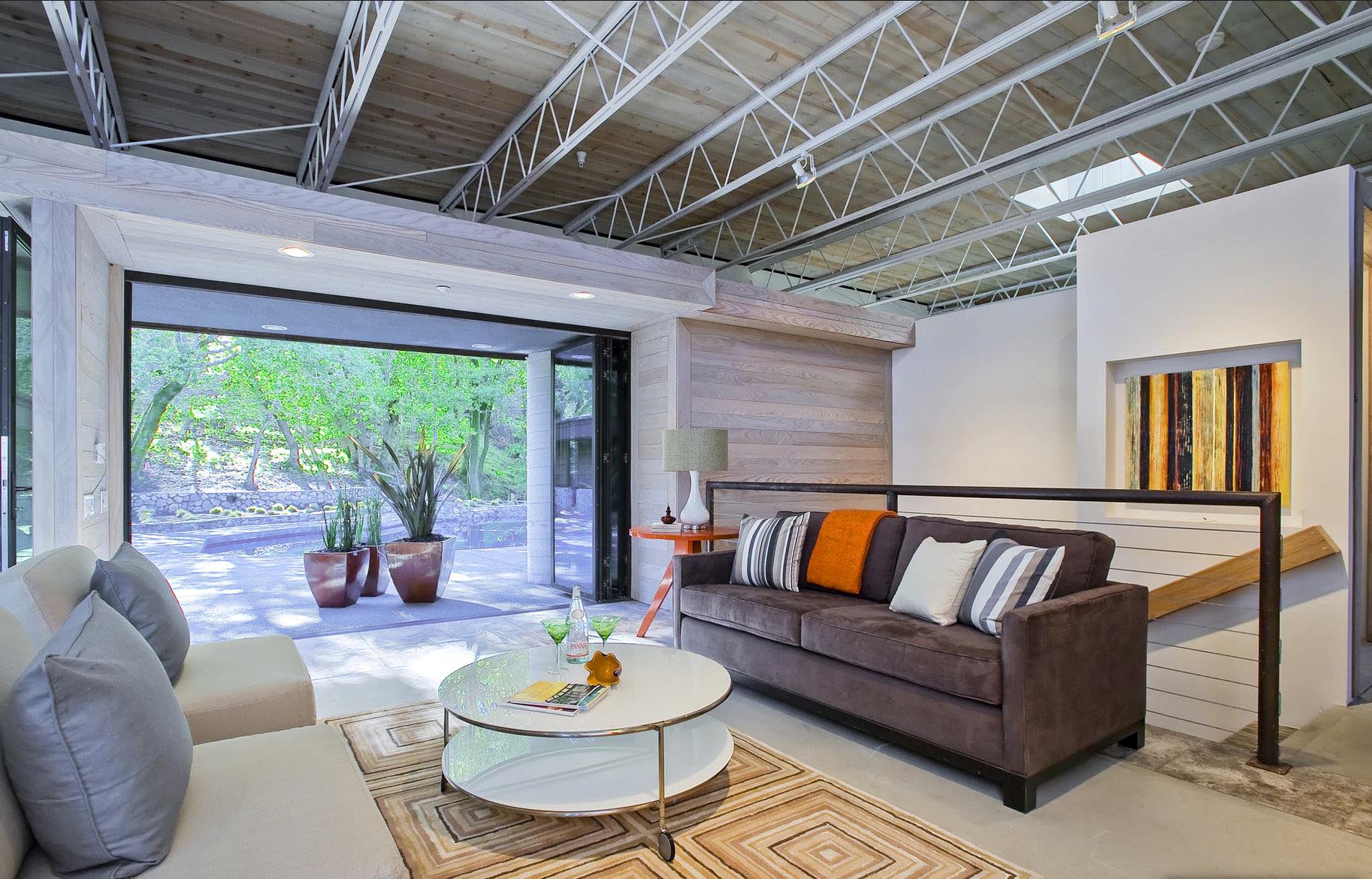 industrial modern remodel with folding glass wall in living room