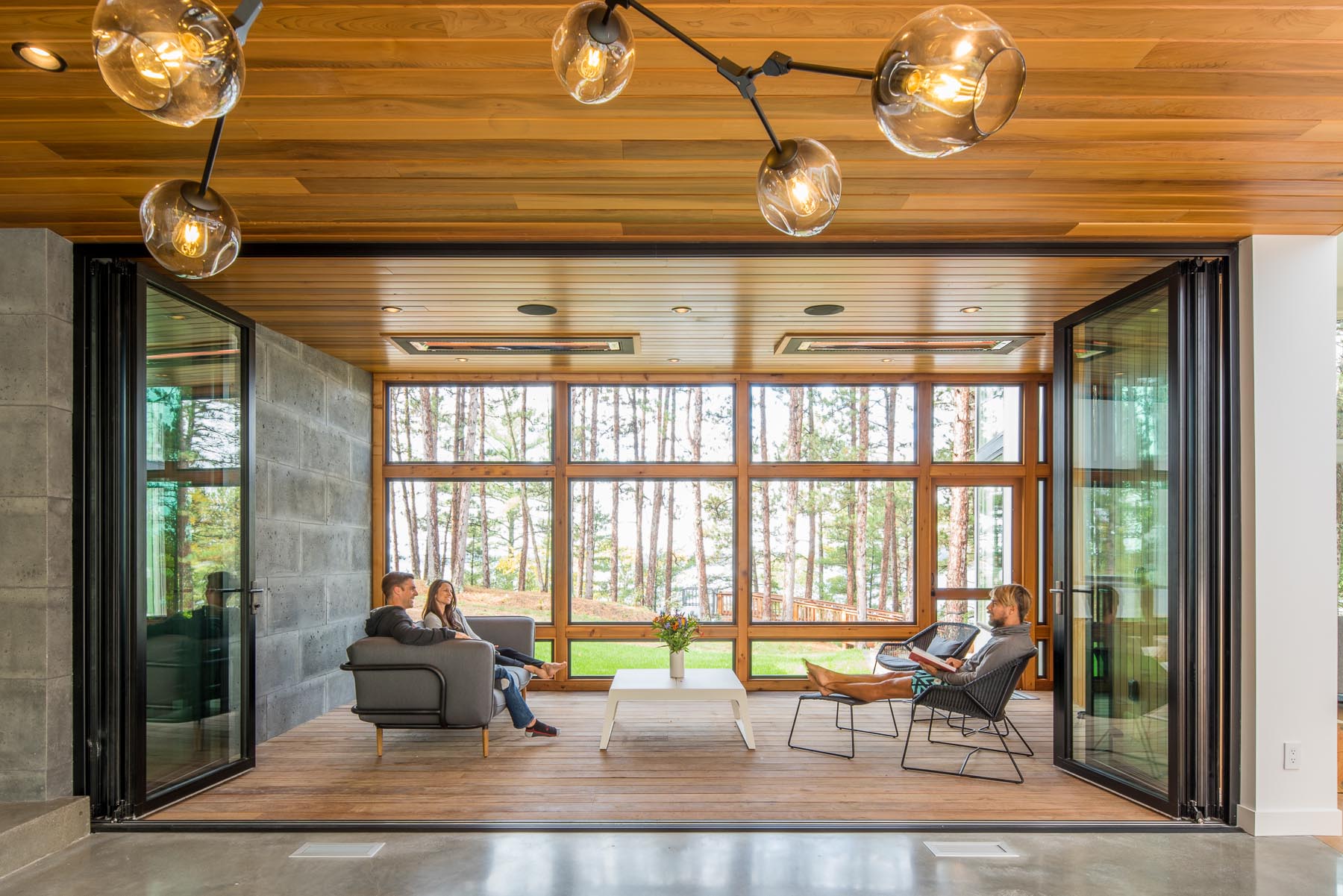 A 3-season porch with opening glass wall system in Minnesota home. 